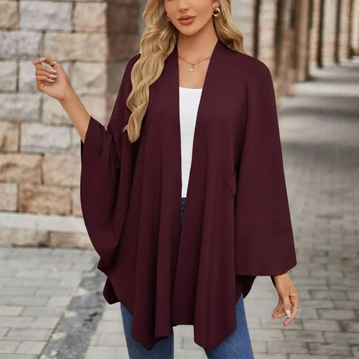 Versatile women's draped poncho, a flowing one-size fashion wrap, elegant & comfortable for stylish layering.