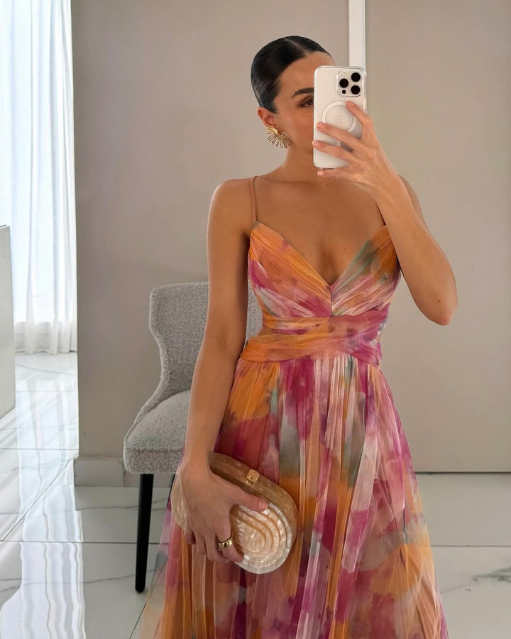 Stylish women's printed mesh maxi dress with spaghetti straps, offering a flattering fit for summer parties.