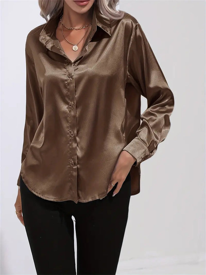 Fashionable elegant women's blouse, flowy long-sleeve top. Perfect for evening chic or office style.