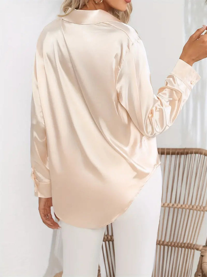 Chic women's button-down blouse, long sleeve & collared. Perfect for workwear or evening.