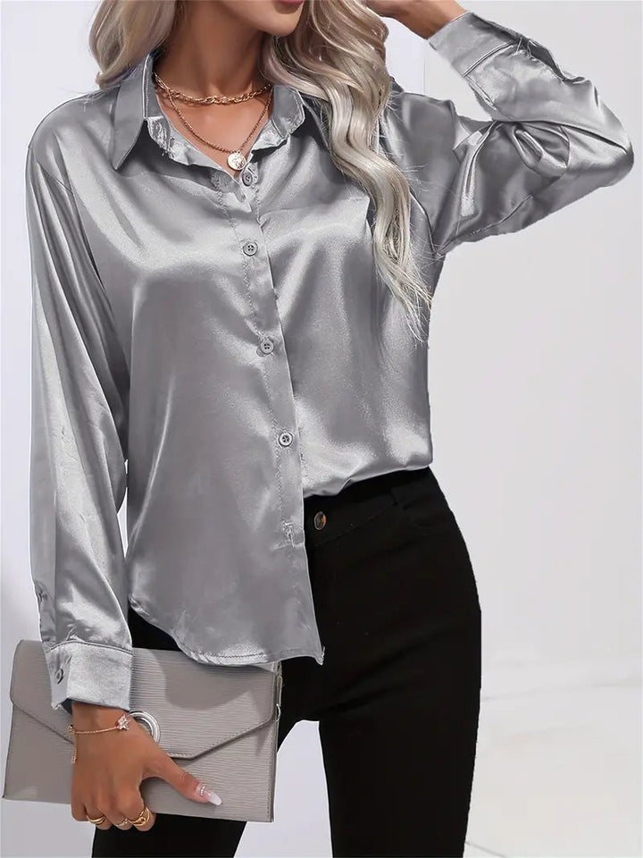 Fashionable elegant women's work blouse, flowy long-sleeve top. Chic for professional or evening.