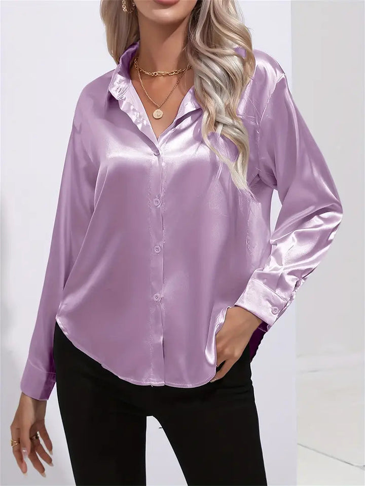 Fashionable women's flowy blouse, elegant long-sleeve top. Chic for evening wear or professional looks.