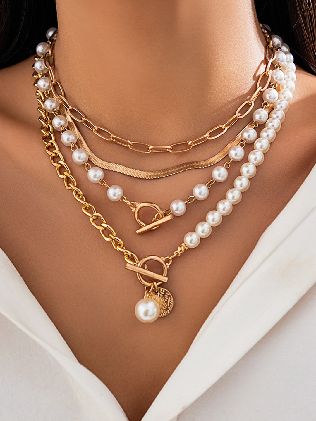 Elegant women's gold-tone layered necklace with delicate chains and lustrous pearl decor, perfect fashion accessory.