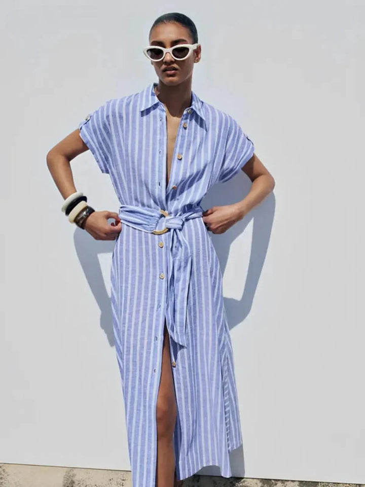 Women's stylish button-down maxi dress in light blue stripes with a flattering self-tie belt. 