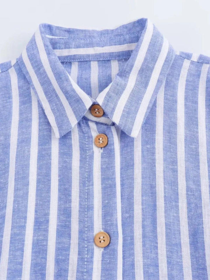Close-up of the fabric and button details on a light blue striped belted women's maxi dress.