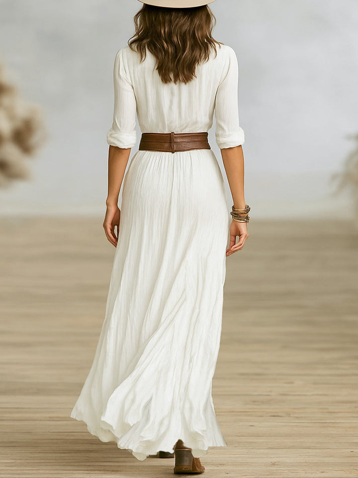 Sophisticated women's elegant long dress with stylish pleated lapels & a cinching belt. Ideal for evening or work.
