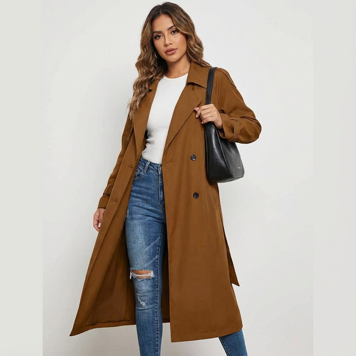Full-length image of a woman wearing a chic long trench coat, showcasing its flattering silhouette and elegant drape.