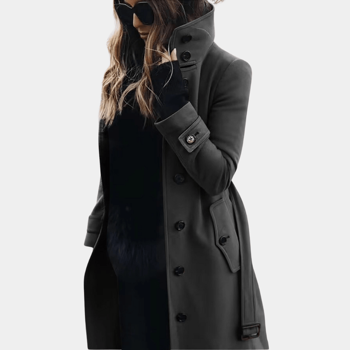 Women's elegant winter outerwear: a long trench coat. Classic double-breasted, tailored for sophisticated fashion.