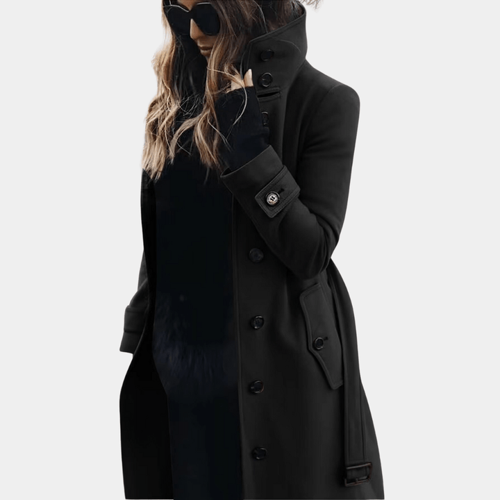 Women's elegant long trench coat. Classic double-breasted design, sophisticated winter outerwear with tailored fit.