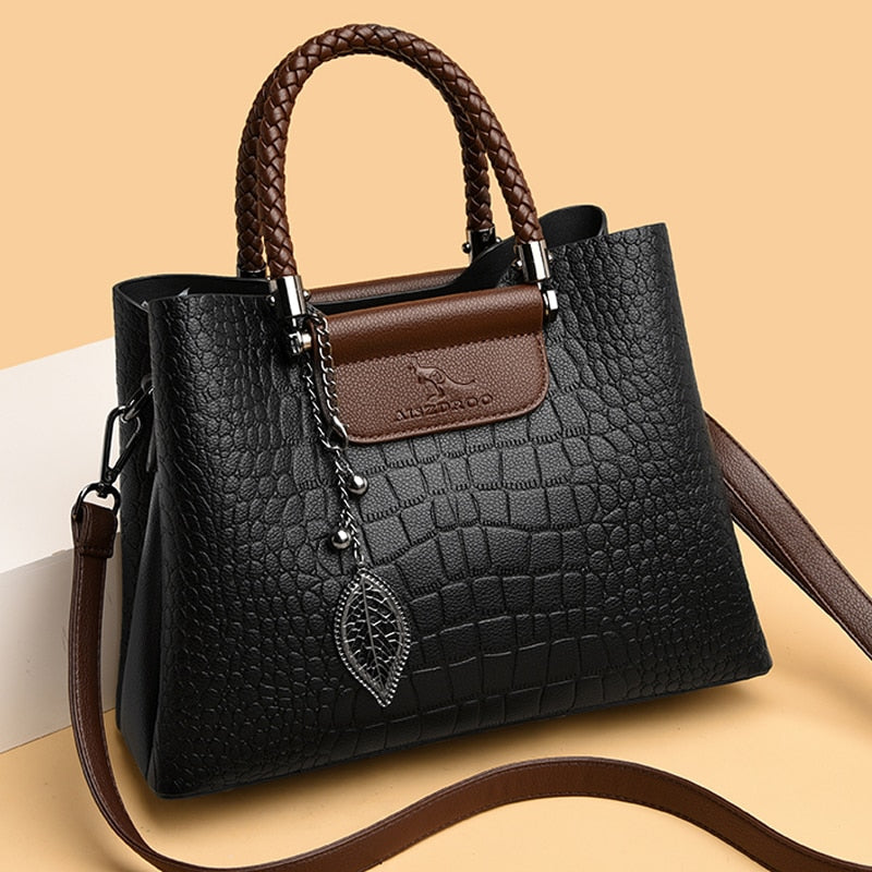 Elegant women's luxury black leather handbag with multi-compartment design, versatile for any occasion.