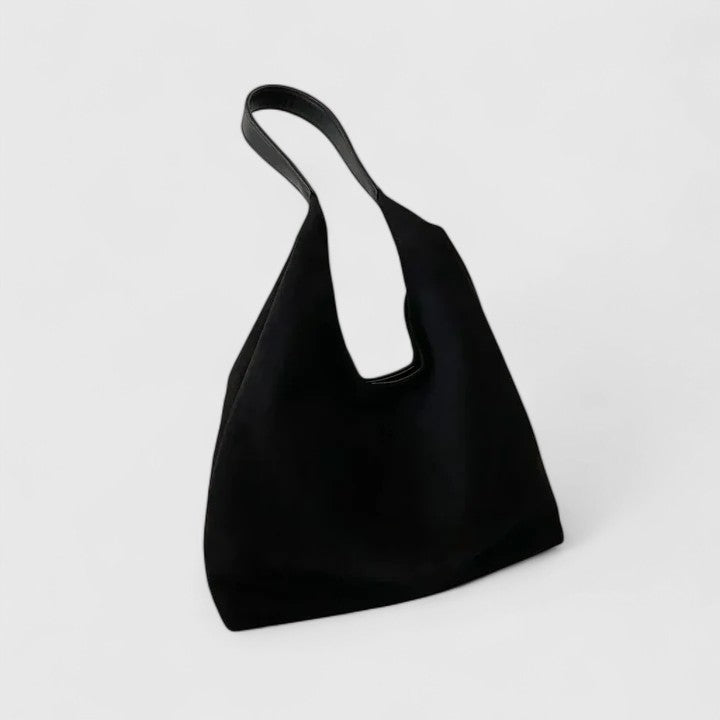 Fashionable women's elegant shoulder bag. Minimalist vegan leather crossbody, a chic everyday handbag.