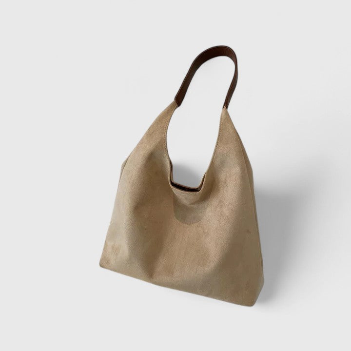 Modern minimalist women's shoulder bag. Elegant vegan leather crossbody, a chic everyday accessory.