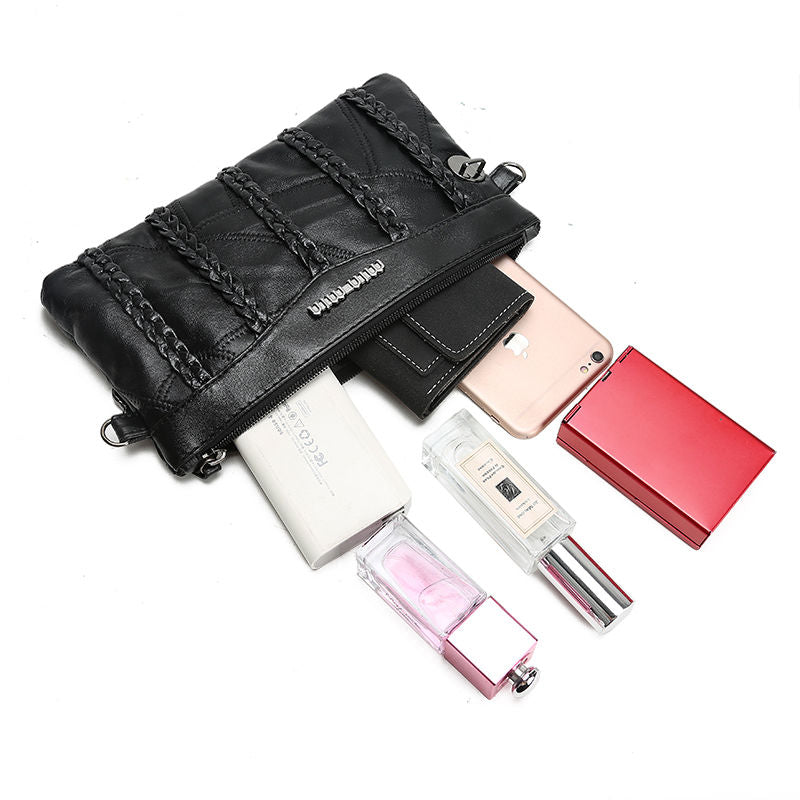 Stylish woman wearing a chic PU leather crossbody clutch, perfect for hands-free casual or evening wear.