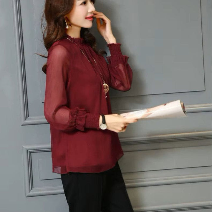 Stylish women's blouse with delicate ruffles and transparent puff sleeves, ideal for elegant summer style.