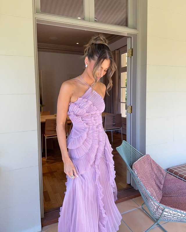 Long women's ruffled halter maxi dress, a chic and flowy evening gown for formal occasions.