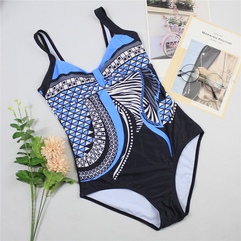 Elegant women's shaping swimsuit, black, providing a flattering fit and tummy control for poolside style.