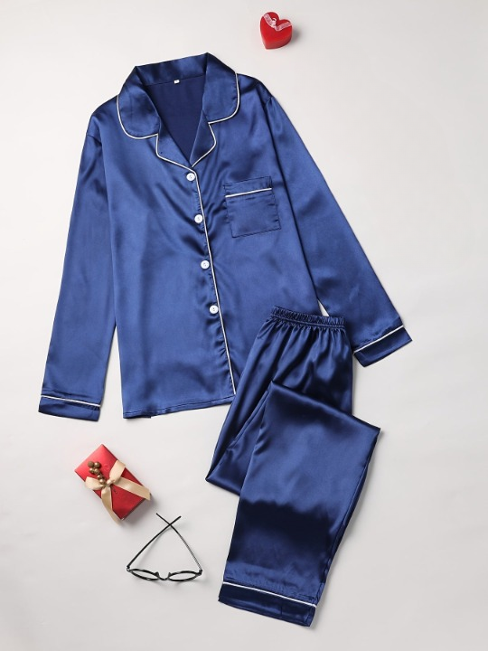 Woman in relaxed-fit silken pajama set; elegant design for comfortable sleepwear & loungewear.