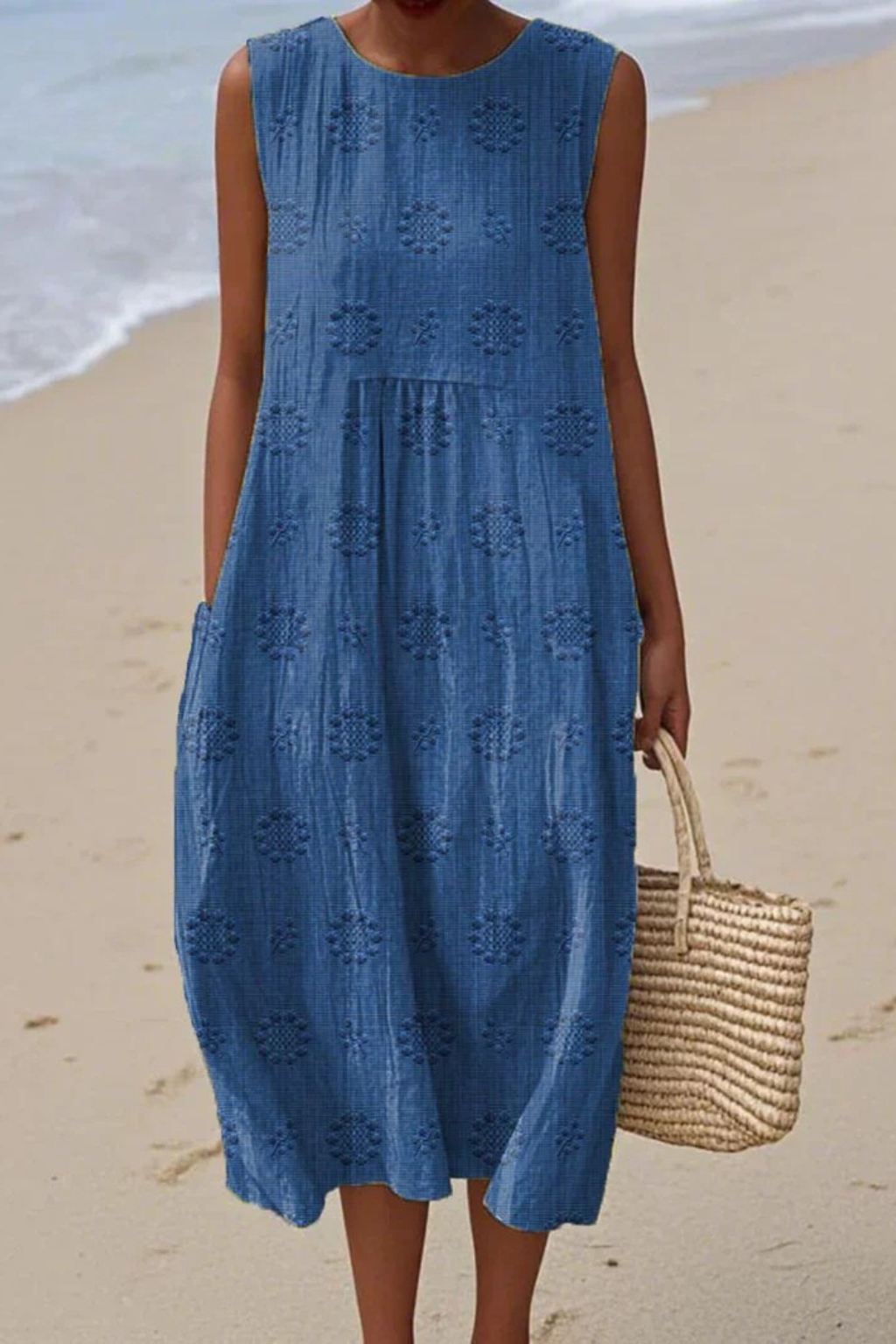 Feminine embroidered sleeveless dress for women. Elegant midi length, great for warm weather fashion.