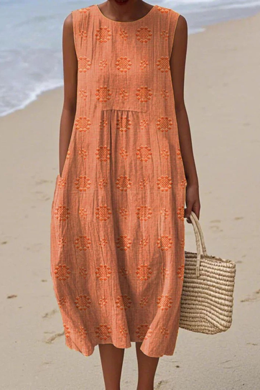 Comfortable women's flowy sleeveless dress featuring intricate embroidery. Chic summer or spring style.