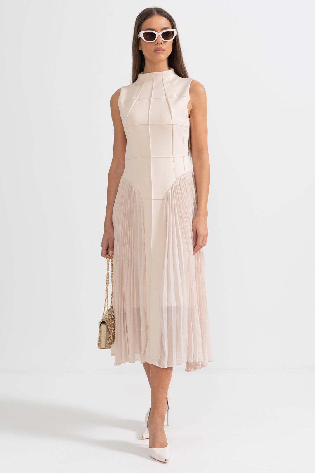 Close-up of the delicate pleats and flowy fabric on this elegant women's sleeveless cocktail midi dress.