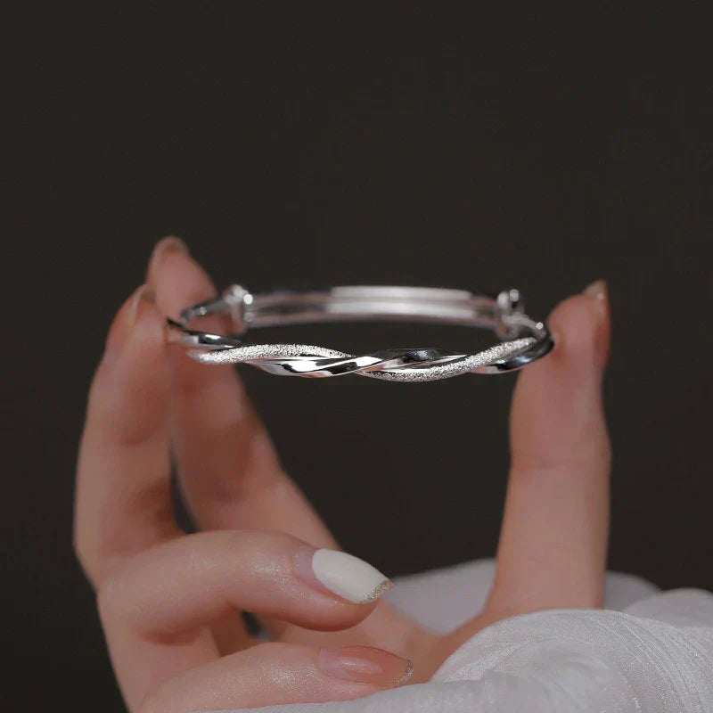 Close-up of an intricate sterling silver bracelet, showcasing its delicate and elegant craftsmanship.