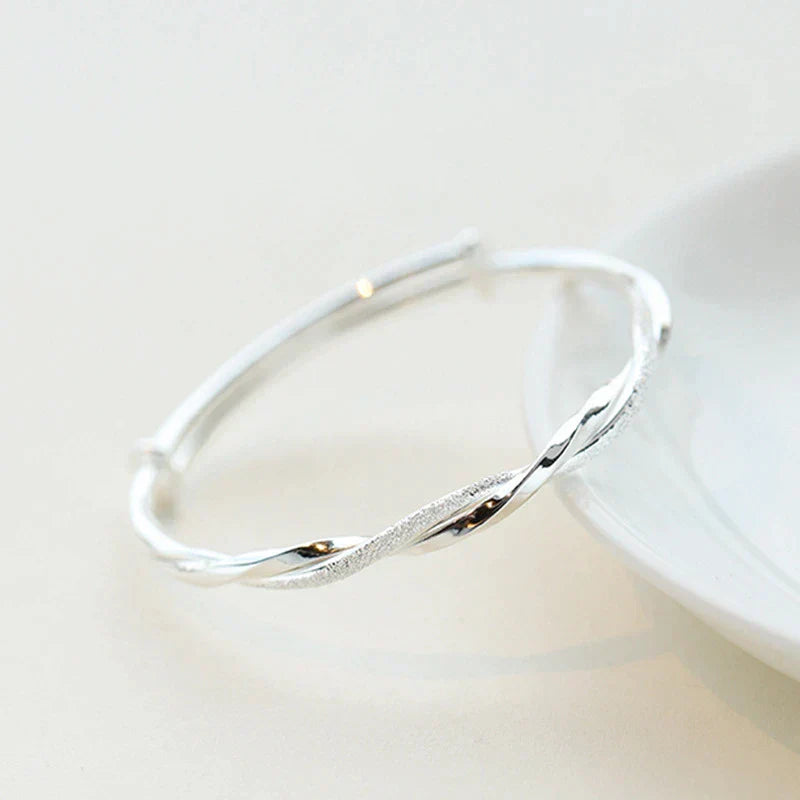 Dainty sterling silver bracelet for women, elegantly adorning a wrist, suitable for any occasion.