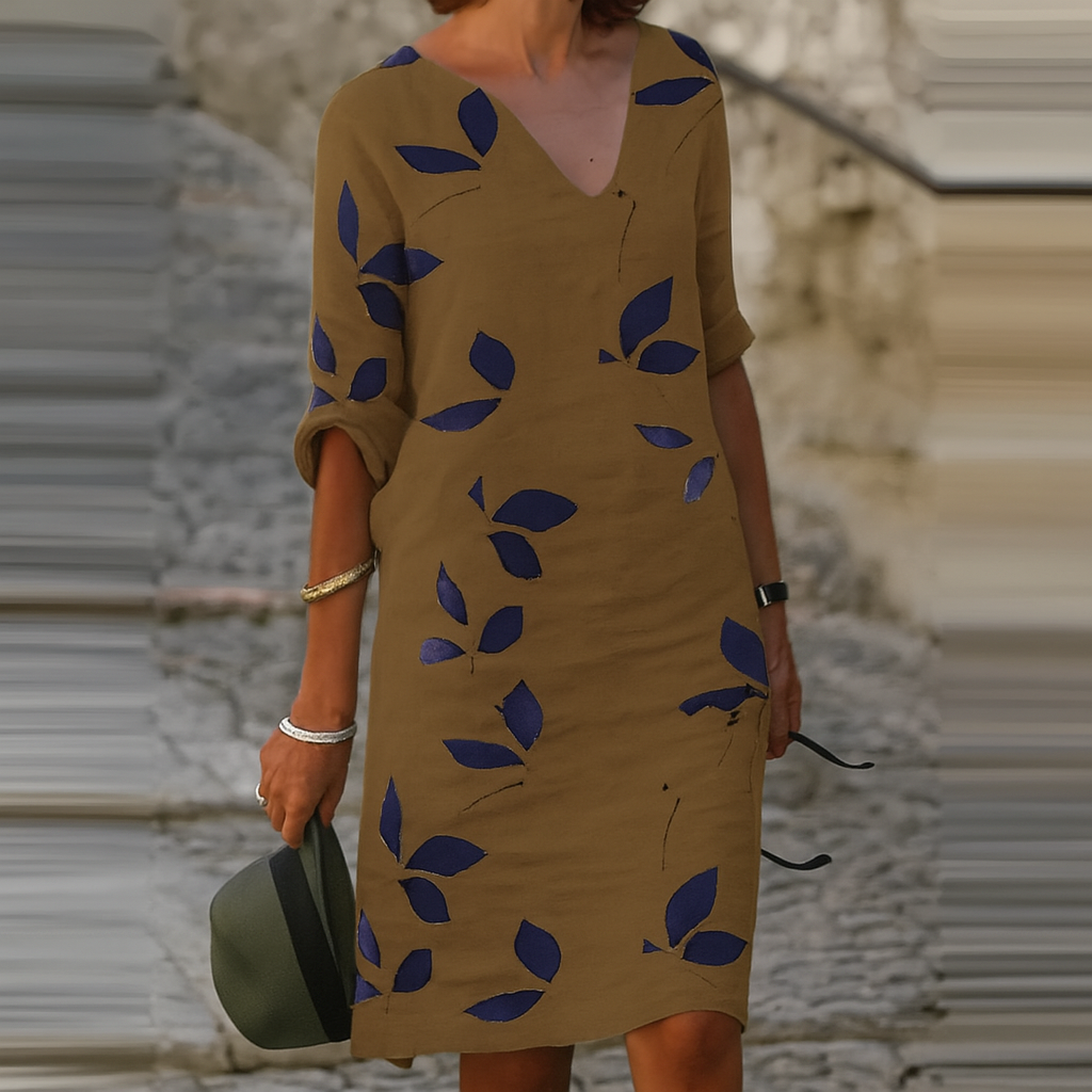 Chic women's summer midi dress featuring a vibrant leaf print, offering an elegant yet casual vacation style.
