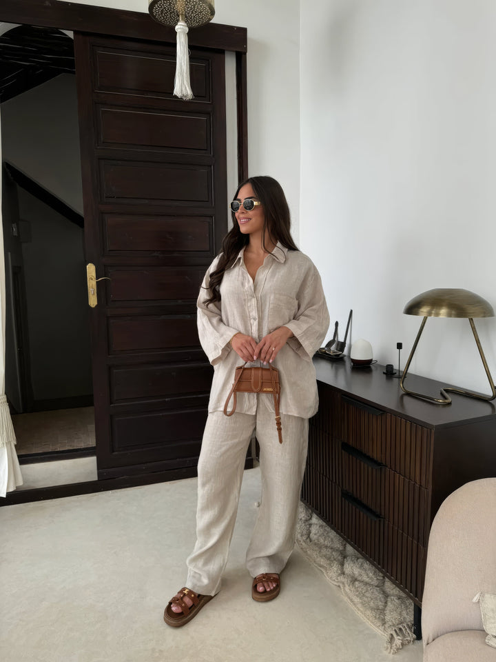 Elegant women's two-piece loungewear set with long sleeve top & wide-leg pants for comfortable casual wear.