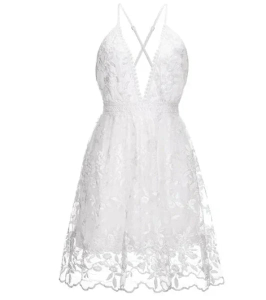 Stylish women's halter mini cocktail dress in white, a perfect beach party or summer wedding guest outfit.