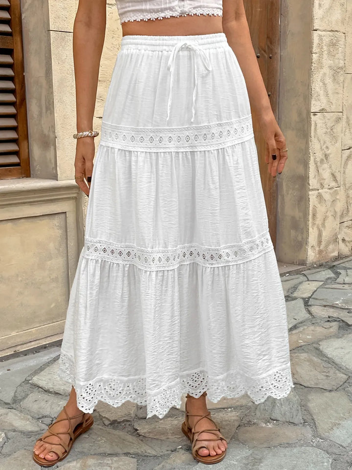 Elegant women's white lace maxi skirt, perfect for summer events & beach vacations. Flowy & stylish.
