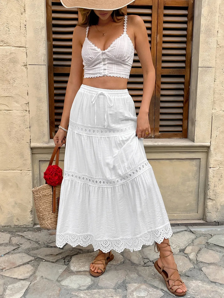 Beautiful tiered white lace maxi skirt with intricate floral details for women. Elegant & breezy summer style.