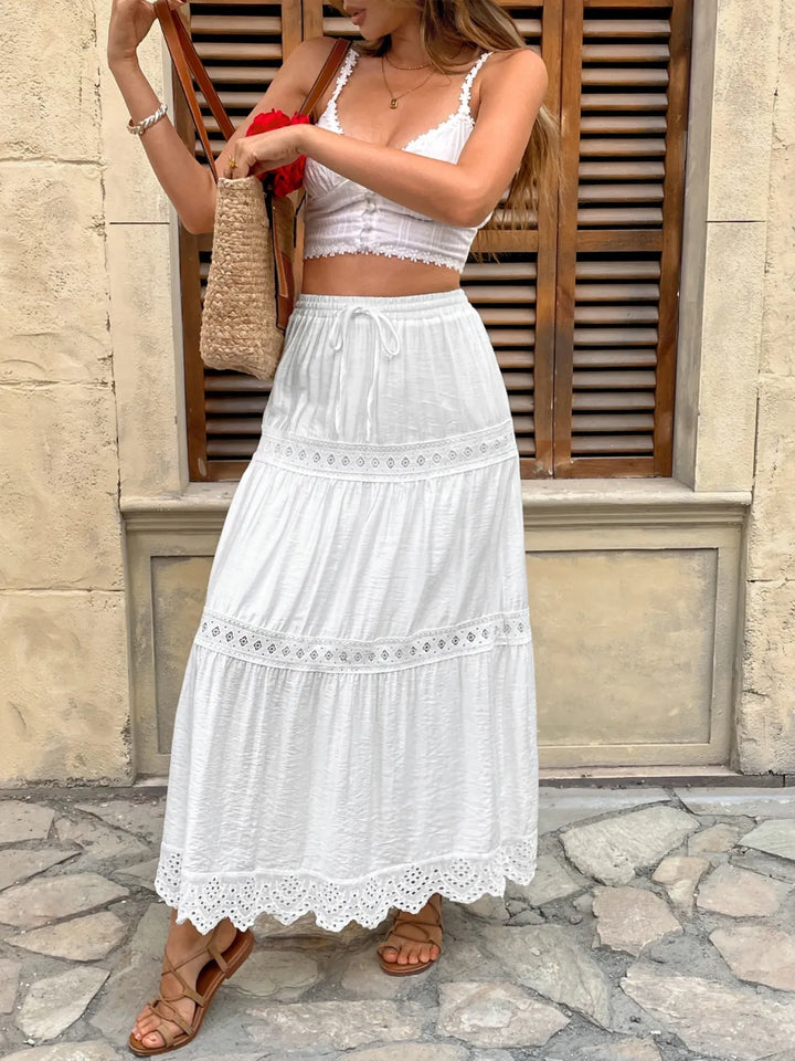 Women's long white lace maxi skirt, great for summer parties, beach days, or a chic boho look. Flowy design.