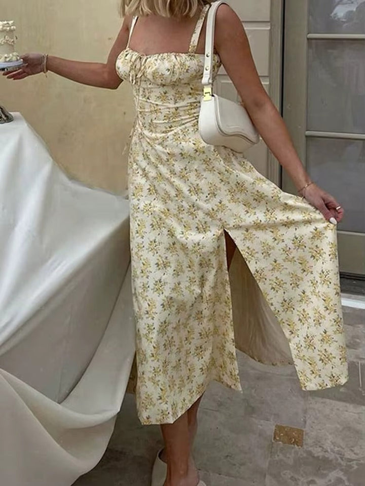 Women's yellow floral summer midi dress with a stylish lace-up front and a subtle side slit detail.