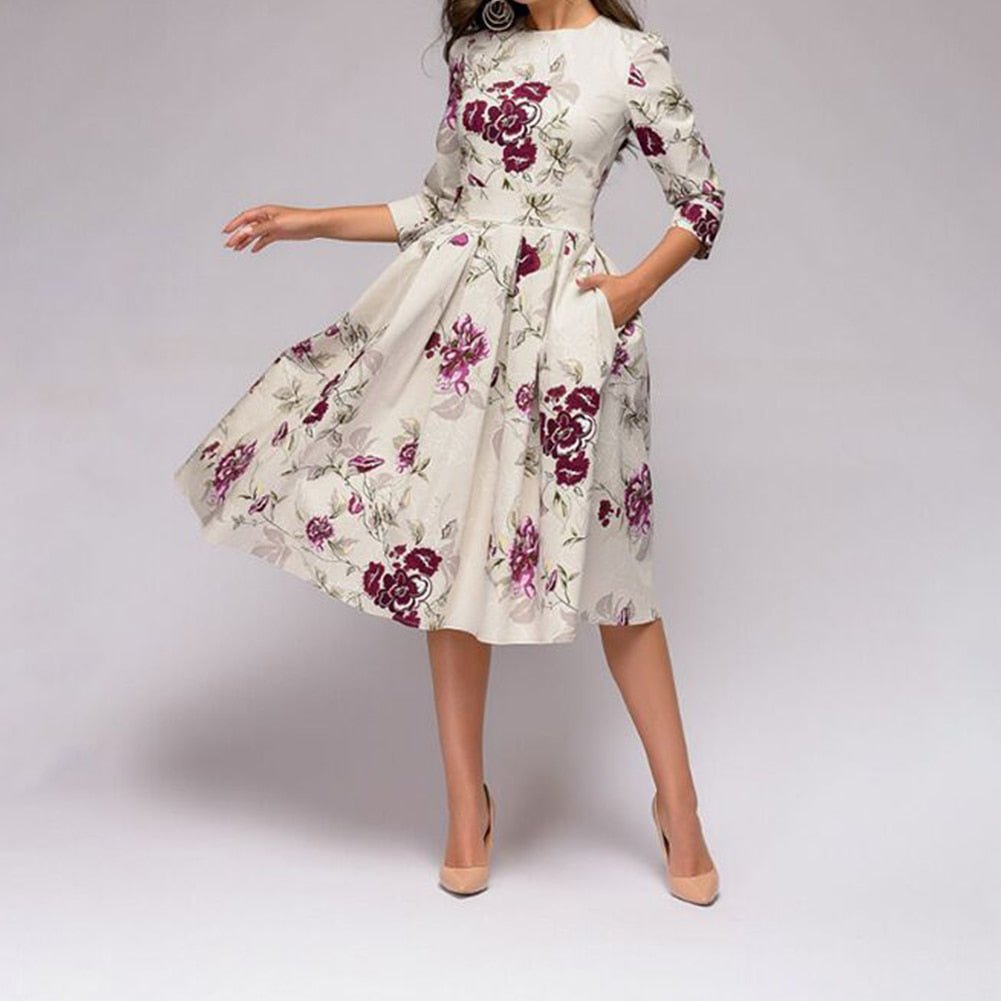 Elegant women's A-line knee-length dress with vibrant floral print, fitted waist, 3/4 sleeves, perfect for spring occasions.