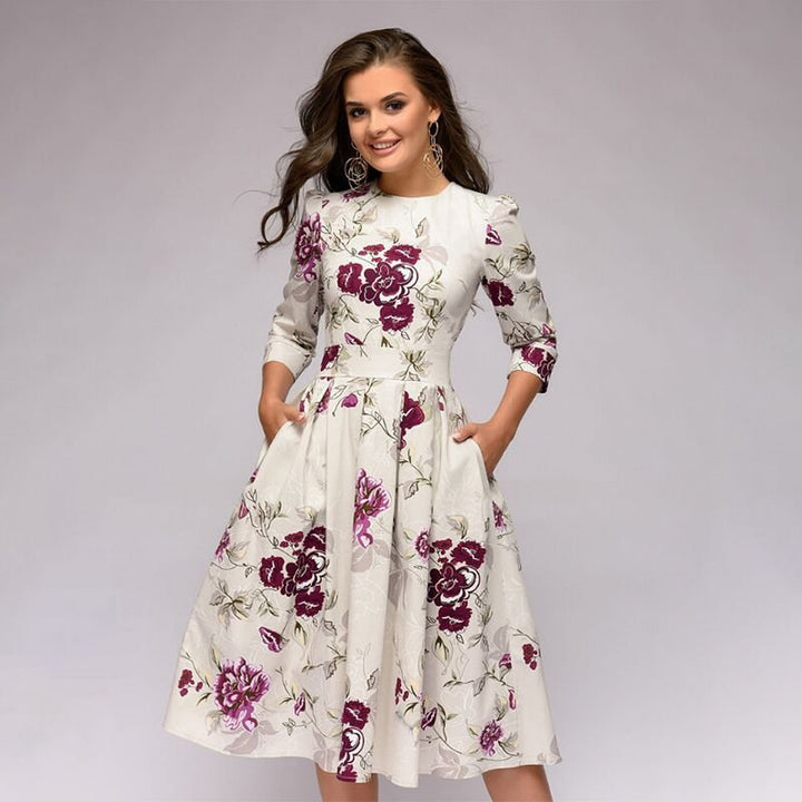 Elegant women's A-line knee-length dress with vibrant floral print, fitted waist, 3/4 sleeves, perfect for spring occasions.