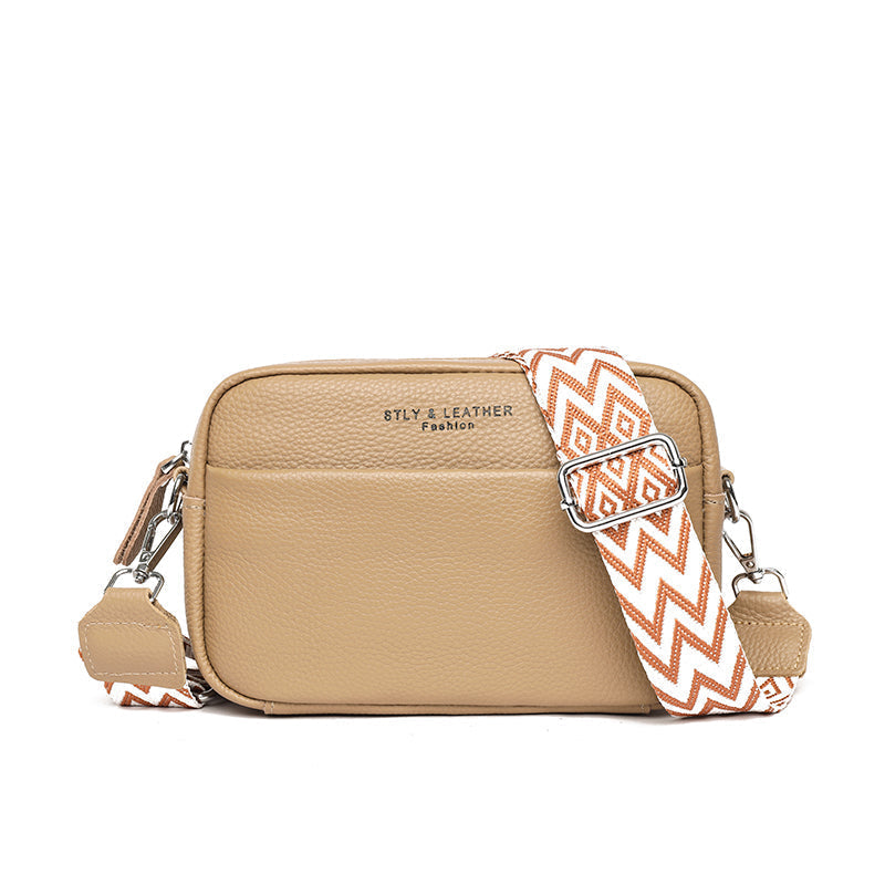 Elegant women's leather crossbody bag with adjustable strap, pebbled texture, ideal for casual or formal occasions.