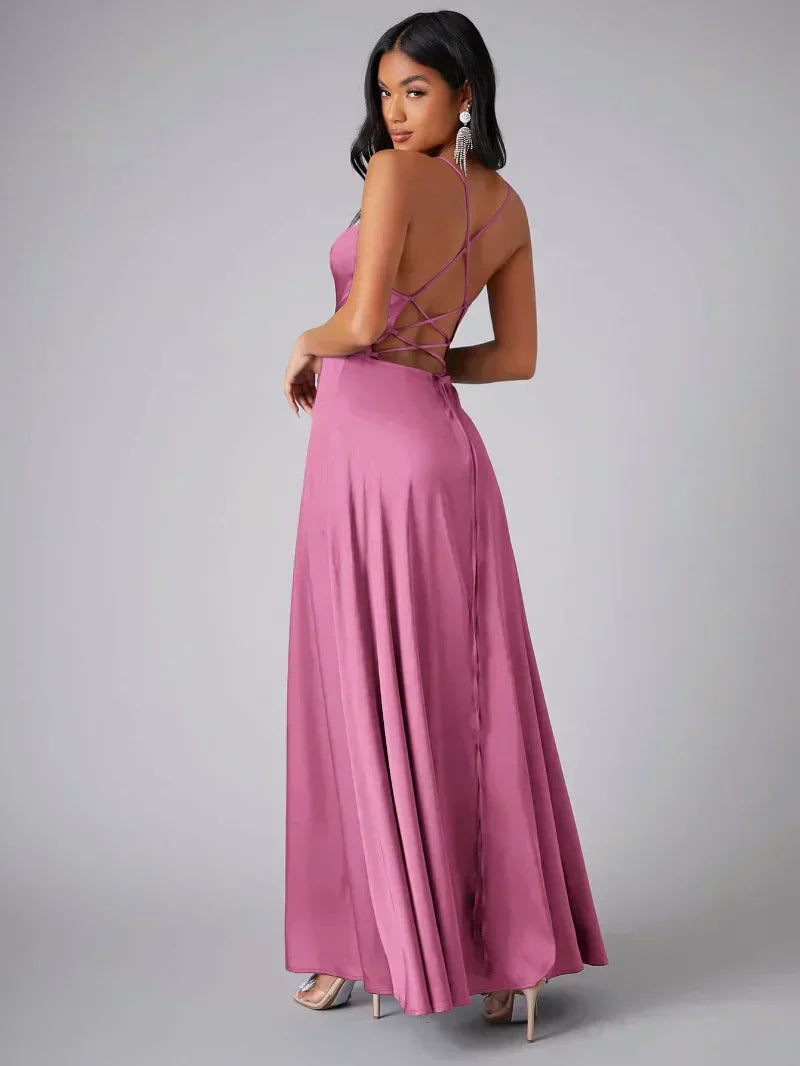 Elegant women's maxi dress with high slit and open back, featuring a figure-flattering silhouette and criss-cross design.