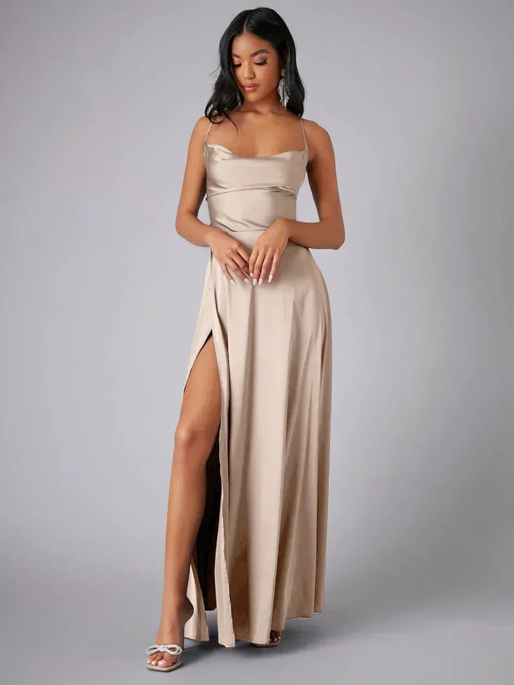 Elegant women's maxi dress with high slit and open back, featuring a figure-flattering silhouette and criss-cross design.