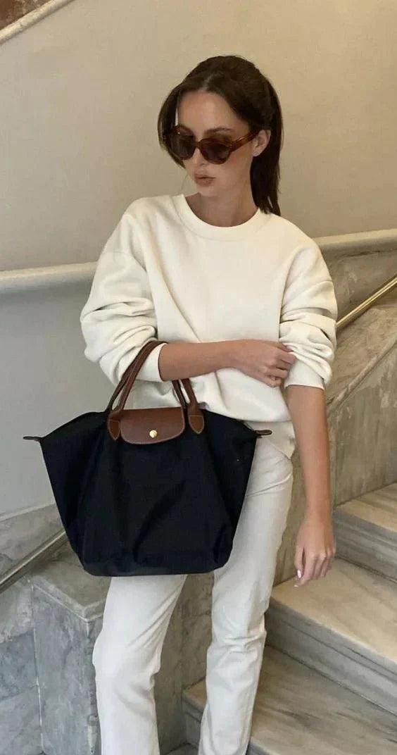 Elegant women's shoulder bag with adjustable straps, spacious interior, chic design for style and functionality.