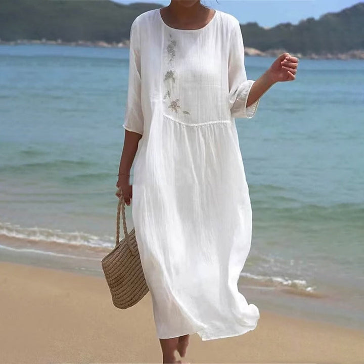 "Elegant women's white maxi dress, flowing silhouette, ideal for summer beach outings and casual elegance."