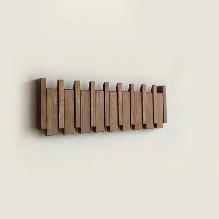 "Elegant wooden coat rack with piano key design, featuring multiple hooks for organizing coats and accessories."