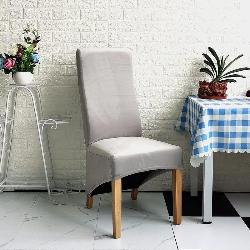 Elegant XL stretch velvet dining chair cover in camel, showcases plush velvet texture, ideal for home or events, fits armless chairs.