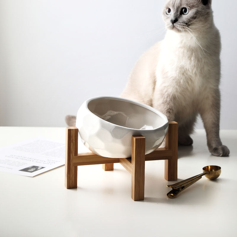 "Ergonomic elevated pet bowl with non-slip wooden stand, sleek design, blue color, enhances pet comfort and posture."