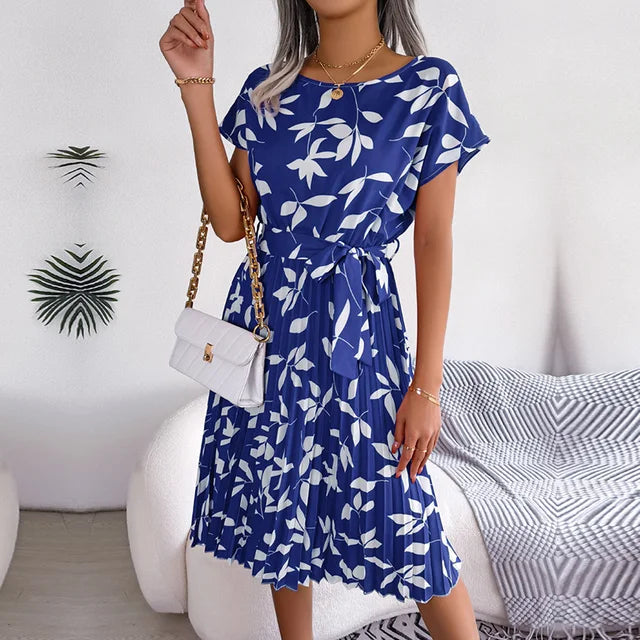 "Floral short-sleeve pleated midi dress with waist tie, offering elegance and comfort for any occasion"