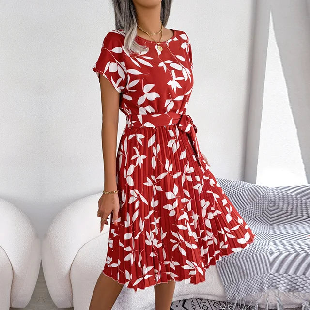 "Floral short-sleeve pleated midi dress with waist tie, offering elegance and comfort for any occasion"