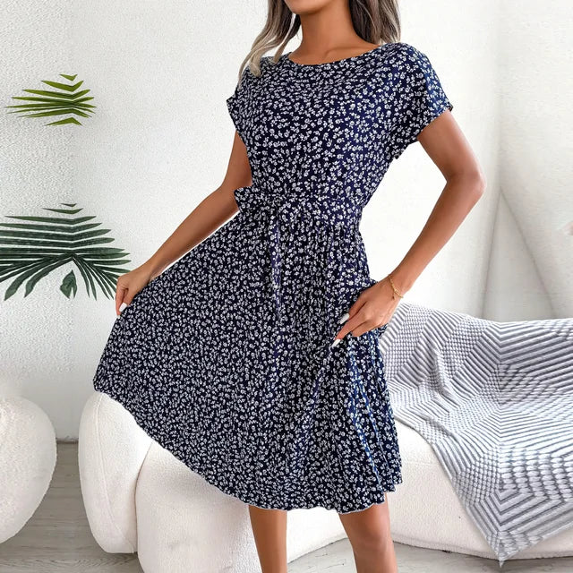 "Floral short-sleeve pleated midi dress with waist tie, offering elegance and comfort for any occasion"