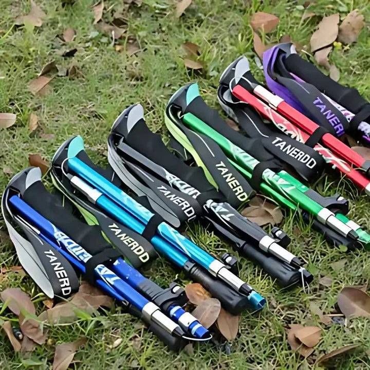 Foldable aluminum trekking pole with adjustable height, lightweight and portable, ideal for hiking, shown in multiple colors.