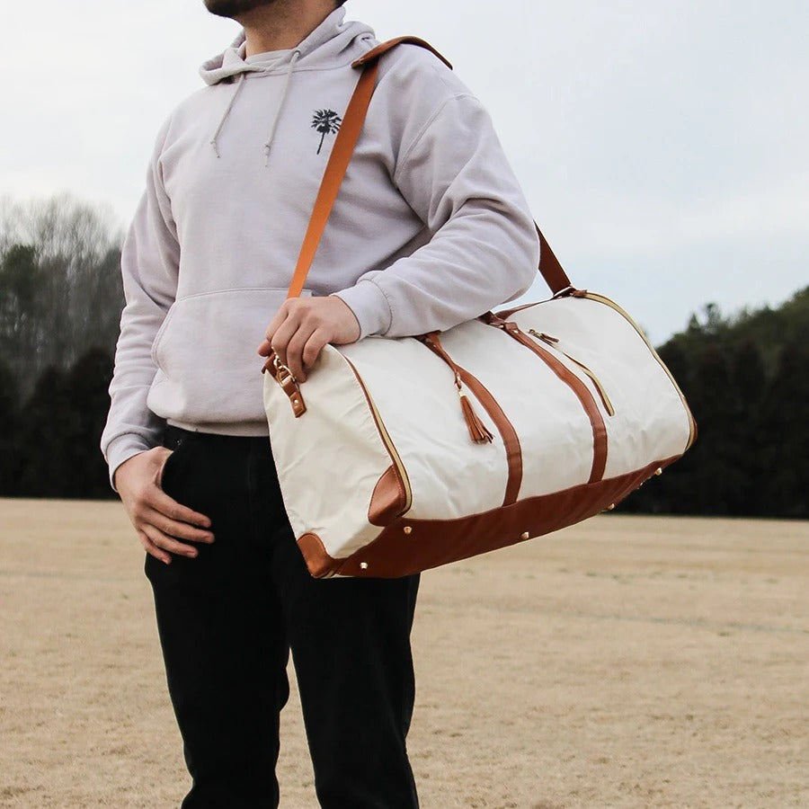 "Foldable smart carry-on bag with sleek design, multi-compartment storage, vegan leather, and garment cover for travel."