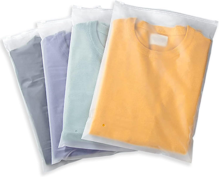 Folded shirts stored efficiently in frosted multi-purpose zip bags for drawer organization.