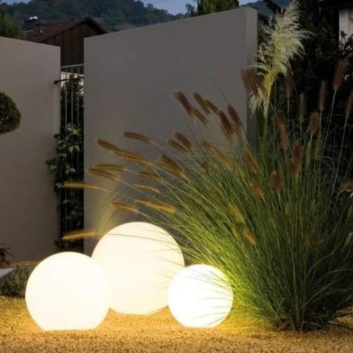 Modern spherical LED home accent light, enhances outdoor decor with soft, color-changing garden illumination.